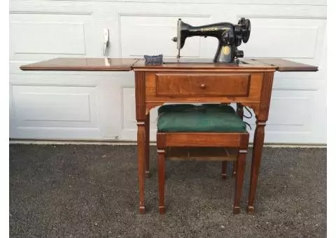 Antique Singer sewing machine in wood cabinet table with bench and supply's